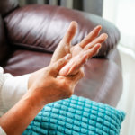 Woman with carpal tunnel symptoms, checking out her hand.