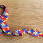 Autism Awareness Month 2021 ribbon with puzzle pieces used as the symbol for autism awareness and acceptance.