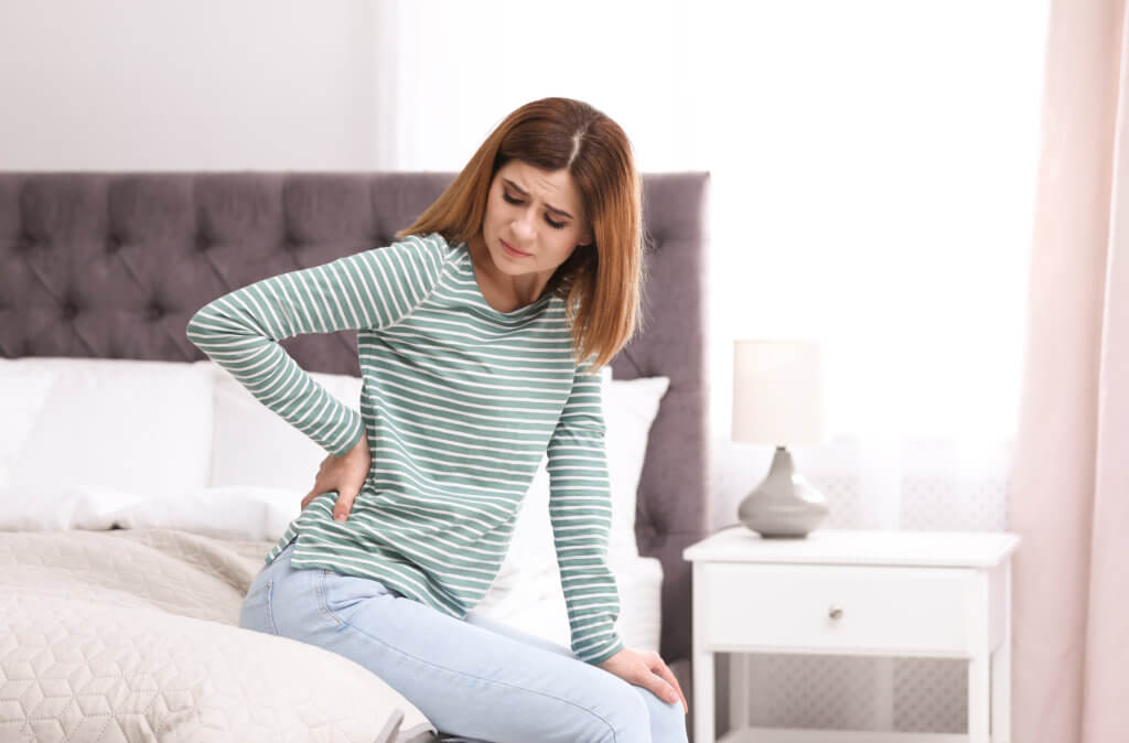 Woman suffers back pain at home