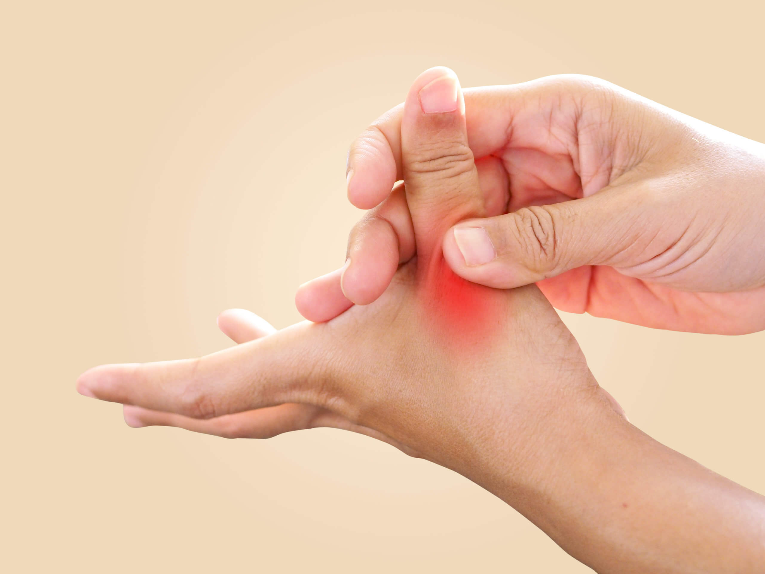 An image of two hands shows one rubbing the thumb of the other with a hot spot indicating pain. 