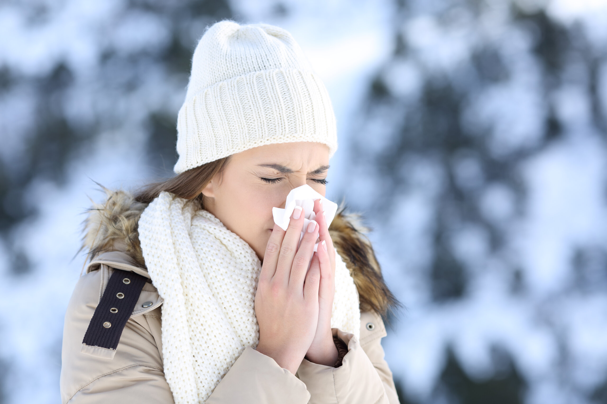 Woman blowing her nose in the snow. 