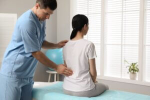 Doctor treating patient at back pain relief center.