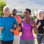 A group of older adults run together outside.