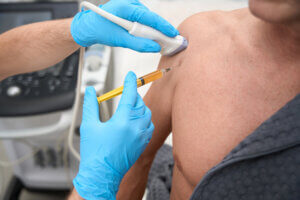 Ultrasound-guided injection performed by a physician on a patient’s shoulder