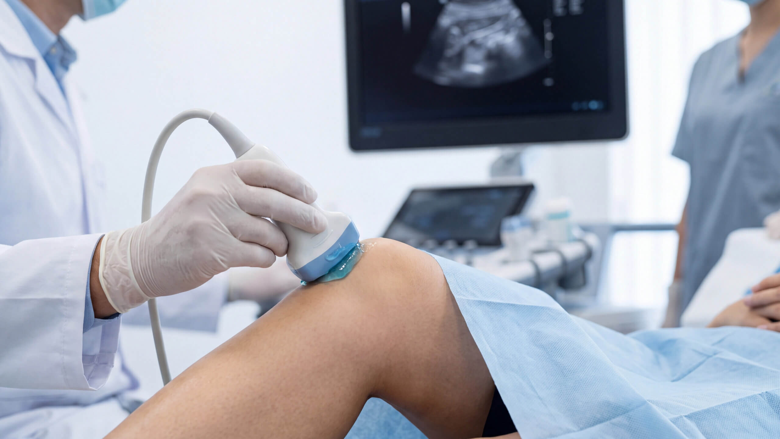 Orthopedic provider performing a knee ultrasound for a patient on Long Island