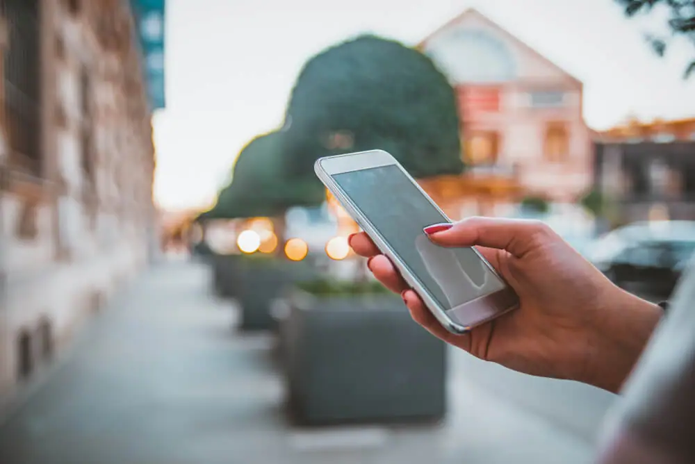  Woman uses her phone while out and about in town. 