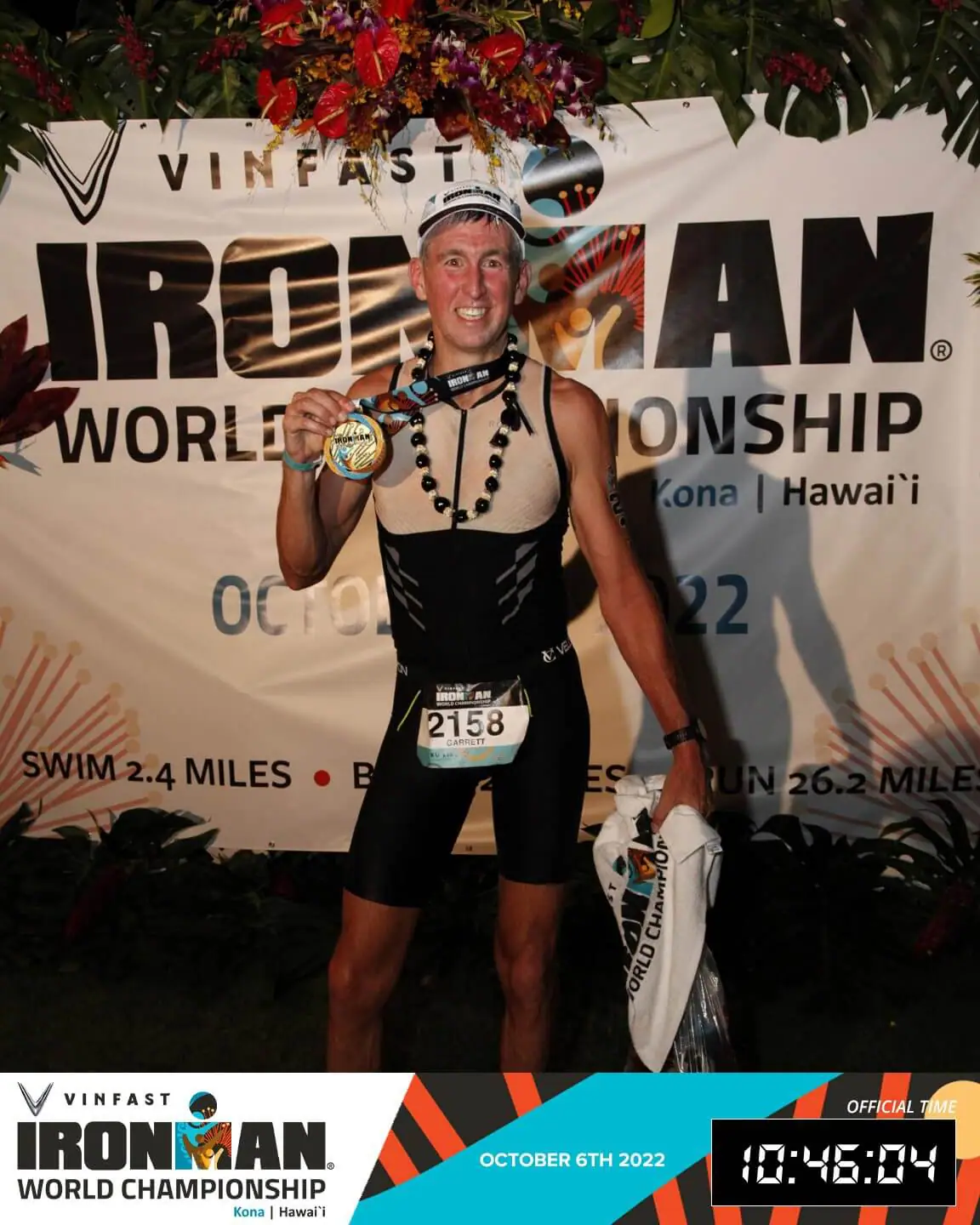 Dr. Garrett Moss in front of the IronMan World Championship sign, with a medal around his neck. Bottom of the image has the IronMan logo, the date: October 6, 2022, and his time listed as 10:46:04